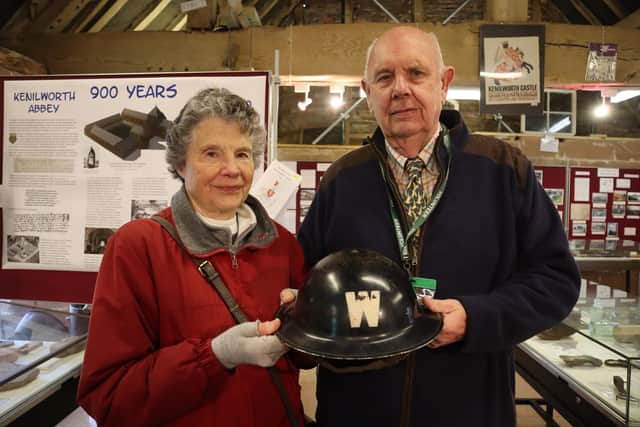 The photo shows Barry Rose handing over his grandfather's ARP helmet to the curator of the Barn Museum Margaret Kane. Picture supplied.
