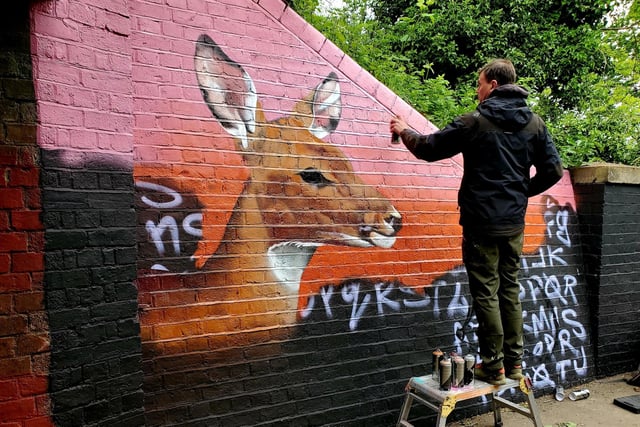 Work taking place on a section of the mural.
