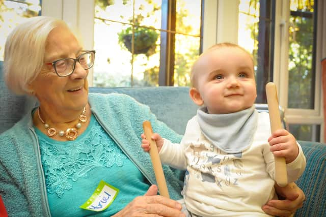 Muriel enjoys a cuddle with baby Chester