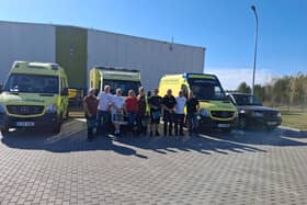 The team of volunteers deliver the ambulances. Picture supplied.