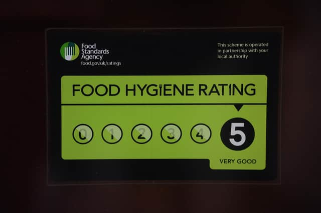 A Food Standards Agency rating sticker on a window of a restaurant in central London. A huge variation in food hygiene standards remains across the UK, with one in five high or medium-risk food outlets failing to meet standards, according to a study.