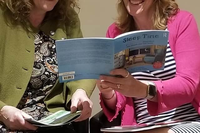 Kate Freeman (right) and her illustrator Jenny Edge  with a copy of one of the Words Together books. Photo courtesy of Sally Jones.