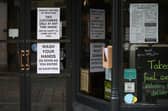 Signs in a coffee shop in Main Street Fort William as people are asked to stop travelling to the Scottish Highlands in a bid to avoid spreading the coronavirus (Photo: Jeff J Mitchell/Getty Images)