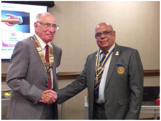 Warwick Rotary President Keith Talbot receives good wishes of Paul Jaspal, outgoing President. Photo by Warwick Rotary Club
