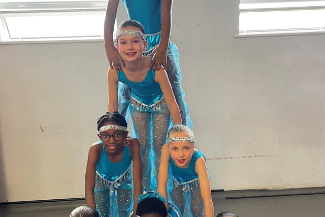 Dancers form a tower.