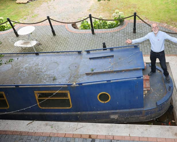 Steven Cuddy with the mini canal lock he built to house a narrowboat turned into a swimming pool on a plot next to his hotel in Coleshill - the barge can travel up to 24 inches.