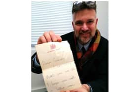 Charles Hansons with the childhood letter from Prince Charles. Photo by Hansons