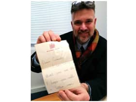 Charles Hansons with the childhood letter from Prince Charles. Photo by Hansons