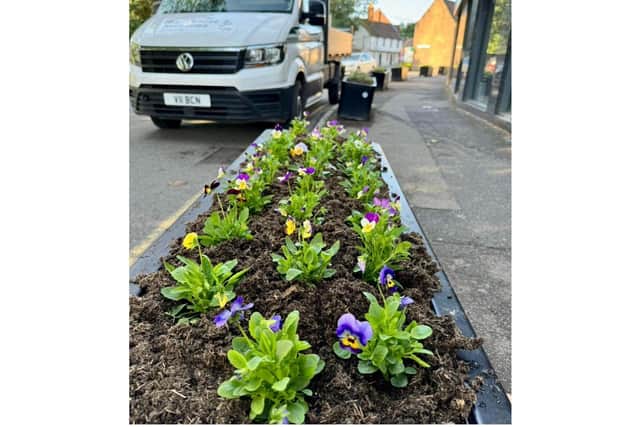 Warwick Town Council has emptied and replanted planters in the St Johns area after being let down by Warwickshire County Council.
