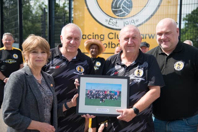 Jill Samuda, Deputy Lieutenant of Warwickshire, launched the event with a presentation of a framed WRWFC photograph to Gordon Dando, (chair of WRWFC), Gary Vella, (chair of Warwick Racing Football Club), whose ground and facilities are used by WRWFC, and Phil Haycock, (author of “Gentlemen! Gentlemen!”, the story of WRWFC, so far, and committee member of WRWFC). Photo by Gillian Fletcher
