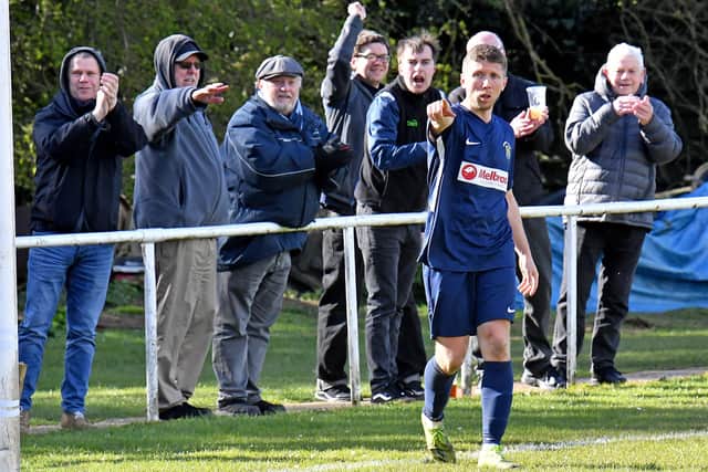 David Kolodynski salutes after scoring Rugby's second goal against Rothwell Corinthians
