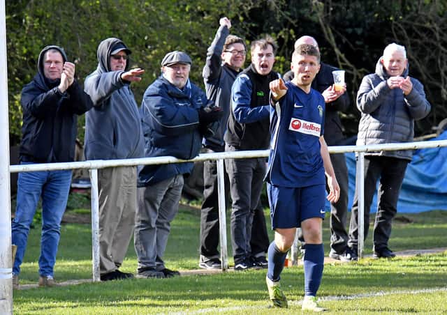 David Kolodynski salutes after scoring Rugby's second goal against Rothwell Corinthians