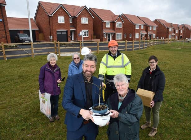 Bellway South Midlands design and planning manager, Rob Earley, holding the oak tree with Jane Murray-Hinde, Budbrooke WI president, at Bellway’s Hampton Trove development in Hampton Magna, watched by (back, from left) Elaine Cross (Budbrooke WI treasurer), Judith Henry (Budbrooke WI secretary), Adam Jones (Bellway site manager) and Rhonda Treacy-Hales (Budbrooke parish councillor).