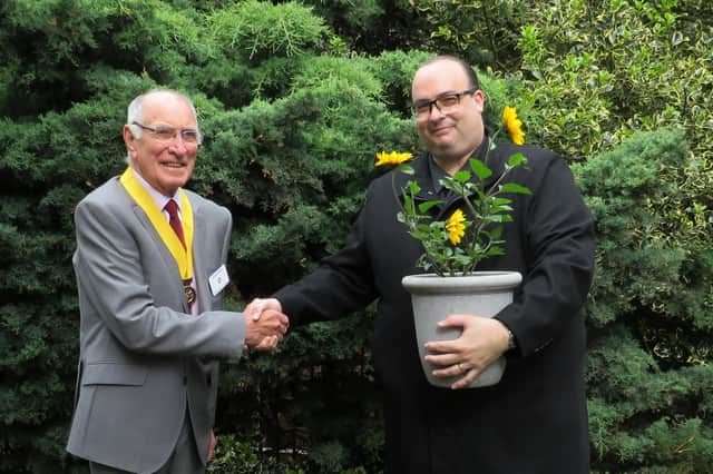 President Elect of Warwick Rotary Keith Talbot presenting headmaster of Westgate Primary School Matthew Watson with a sunflower. Photo supplied