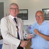 Deputy Lord Lieutenant Richard Hurwood presents the award to John Warren, chair of trustees