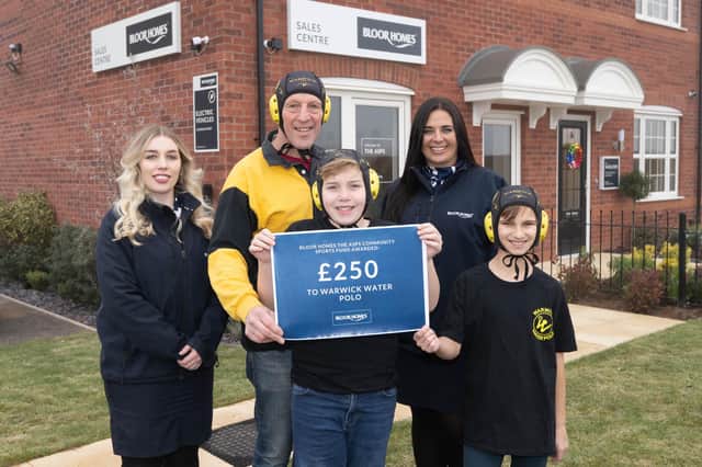 Quentin Hayes (back), Max Footman (centre) and Timur Vlasiuc (far right) from Warwick Water Polo receiving the donation from Bloor Homes at The Asps in Warwick towards caps for the players. Photo supplied