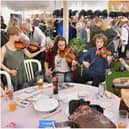 Musicians playing at the bar at a previous Folk Festival. Photo by John Wright
