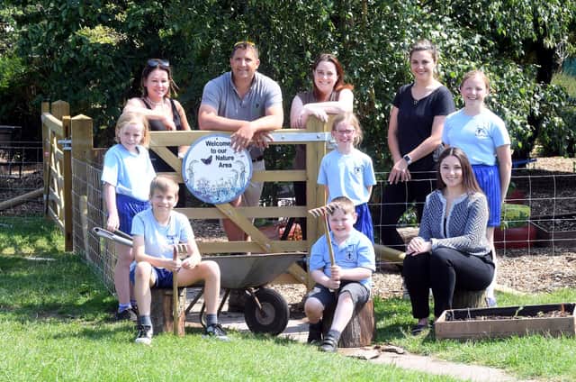 Caption: (l-r) Forest School teacher Lil Ellis, PB Forestry and Landscaping's Phil Bett, school head Catherine Burch, Kirsty Maclean from the PTA, The Wigley Group's Jess Wood, with children