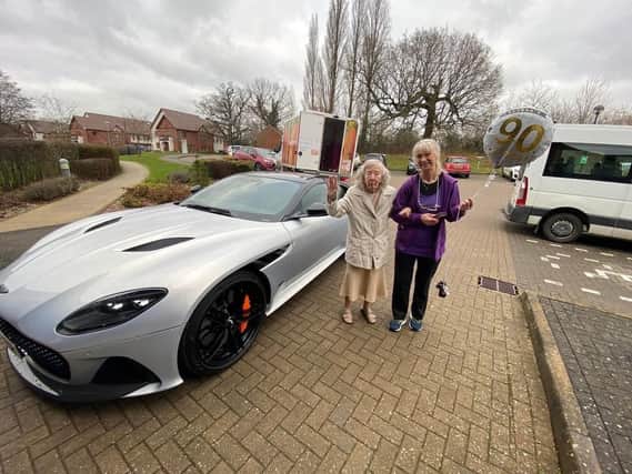 Meg Cottle (left) and her friend Sarah with the Aston Martin outside Harpers Fields care home in Balsall Common.
