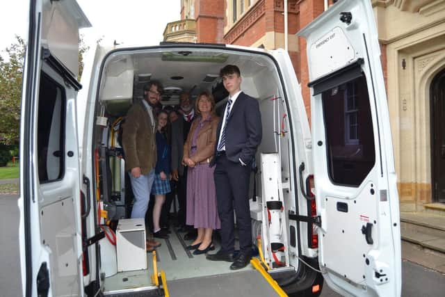 Examining the interior of an ambulance, which will be packed with medical supplies. Photo supplied