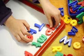 File photo dated 08/02/12 of a child playing, as parents can go online to find out what childcare they are eligible for under plans which will see nurseries expanded to provide more places and funding given to councils for wraparound care.