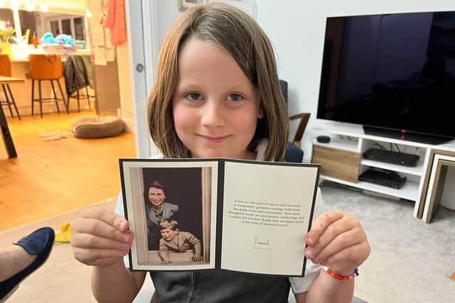 A Member of The St Marks Rainbow Guides shows off the letter from King Charles sent in thanks for the group's messages of condolence which they sent to him when his mother Queen Elizabeth II died in September.