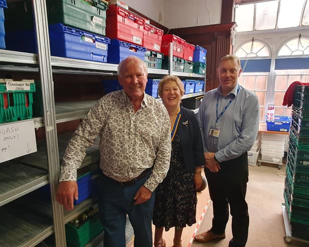 Rotarians Edward Binns and Kate Lawrence, with Adi Robinson, at the foodbank.