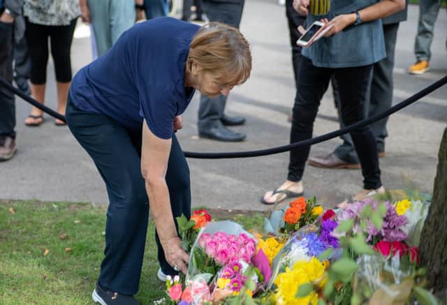 Placing flowersin memory of The Queen.