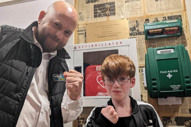 Chris Davies, manager of Yesss Electrical, and Charlie Canavan with the new defibrillator device at Cleary's Boxing Gym. Picture supplied.