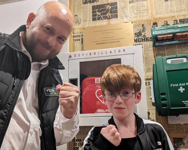 Chris Davies, manager of Yesss Electrical, and Charlie Canavan with the new defibrillator device at Cleary's Boxing Gym. Picture supplied.