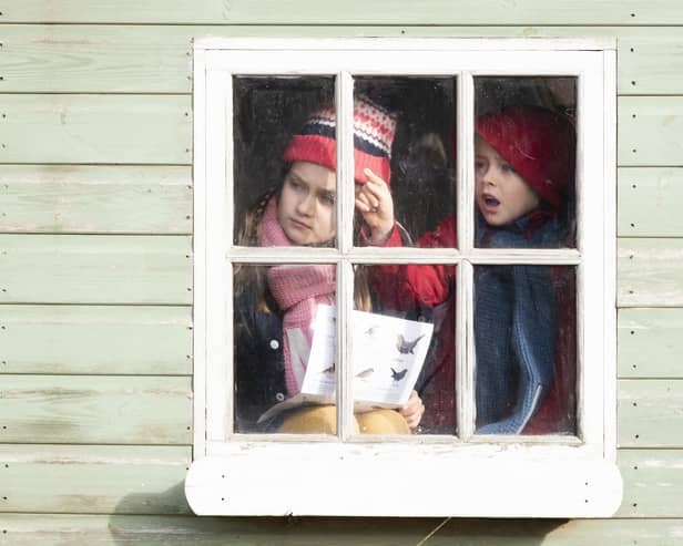 Stills from RSPB Big Garden Birdwatch TV advertisement, Maya and Lewis taking part from inside a playhouse in the garden, Bedfordshire, October 2018 (Image: Eleanor Bentall).