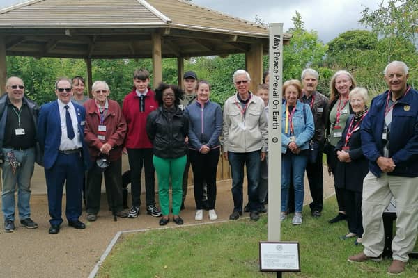 Rotarians, teachers, deputy head Angela Howe and students gather for the peace pole dedication