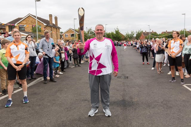 Batonbearer Antony Lewis holds the Queen's Baton during the Birmingham 2022 Queen's Baton Relay visit to Whitnash Civic Centre & Library on July 22 (Photo by Nick England/Getty Images for Birmingham 2022 Queen's Baton Relay)
