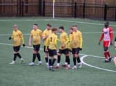 Racing Warwick celebrate their second goal.