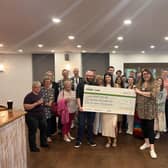 Alex Pearson recently attended the LWS Night Shelter to present the team a cheque for £1,132.56, which was raised through a charity walk. Photo supplied