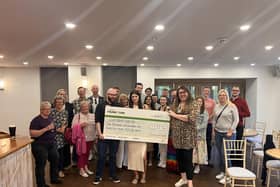 Alex Pearson recently attended the LWS Night Shelter to present the team a cheque for £1,132.56, which was raised through a charity walk. Photo supplied