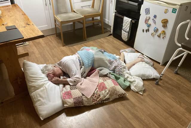 Lilian Delday lies on her kitchen floor during her wait of more than ten hours for an ambulance to arrive after she suffered a broken hip in a fall at her home in Warwick. Picture supplied.