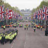 Metropolitan Police officers march along The Mall in London as they head to their positions for of the coronation processions of King Charles III and Queen Camilla.