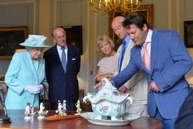 BELFAST, NORTHERN IRELAND - JUNE 25 2014: In this handout image provided by Harrison Photography, Queen Elizabeth II  and Prince Philip, Duke of Edinburgh talk to Antiques Roadshow experts Hilary Kay, John Axford and Paul Atterbury at Hillsborough castle on June 25, 2014 in Belfast, Northern Ireland. The Royal party visited Northern Ireland for three days.  (Photo by Aaron McCracken/Harrison Photography via Getty Images)