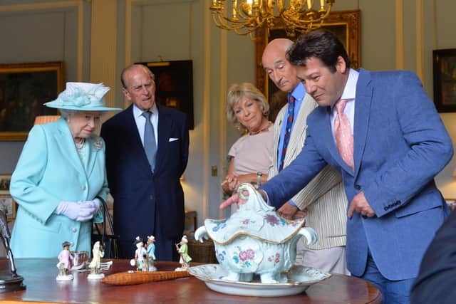 BELFAST, NORTHERN IRELAND - JUNE 25 2014: In this handout image provided by Harrison Photography, Queen Elizabeth II and Prince Philip, Duke of Edinburgh talk to Antiques Roadshow experts Hilary Kay, John Axford and Paul Atterbury at Hillsborough castle on June 25, 2014 in Belfast, Northern Ireland. The Royal party visited Northern Ireland for three days. (Photo by Aaron McCracken/Harrison Photography via Getty Images)