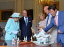 BELFAST, NORTHERN IRELAND - JUNE 25 2014: In this handout image provided by Harrison Photography, Queen Elizabeth II  and Prince Philip, Duke of Edinburgh talk to Antiques Roadshow experts Hilary Kay, John Axford and Paul Atterbury at Hillsborough castle on June 25, 2014 in Belfast, Northern Ireland. The Royal party visited Northern Ireland for three days.  (Photo by Aaron McCracken/Harrison Photography via Getty Images)
