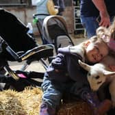 Charlotte and Alana cuddling a lamb