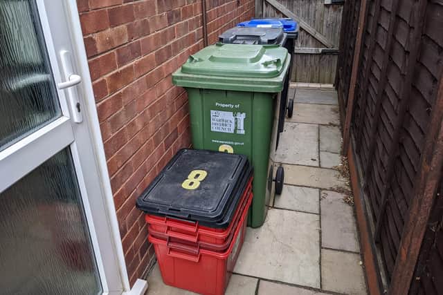 Green, grey and blue-lidded bins and red recycling boxes at a house in the Warwick district.
