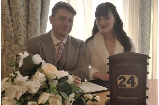 Newlywed couple Georgina and Richard McDonald with the 1930s calendar at Pageant House. Photo supplied by Warwickshire County Council
