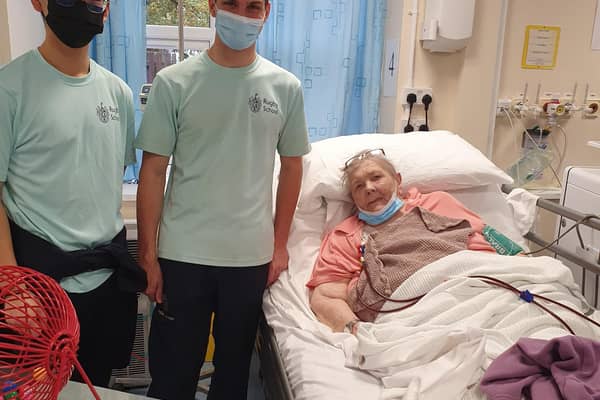 Students from Rugby School congratulated a patient in the Ash Dialysis Unit who won a bingo session.