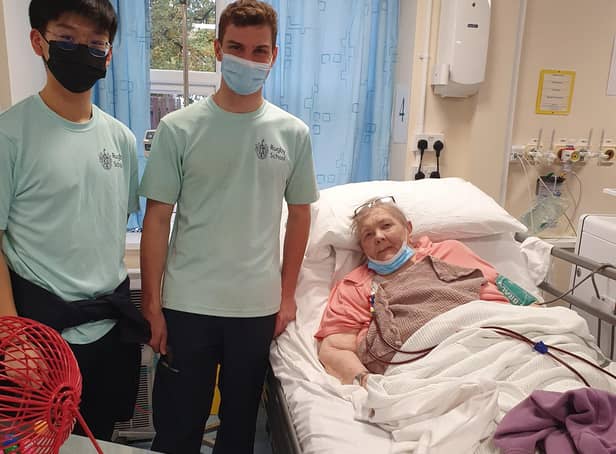 Students from Rugby School congratulated a patient in the Ash Dialysis Unit who won a bingo session.