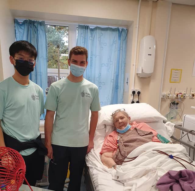 Students from Rugby School congratulated a patient in the Ash Dialysis Unit who won a bingo session.