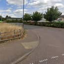 The area to the left of the access road to Cawston's shops has not attracted the hoped-for GP surgery or other community resource so a decision is due on plans to put houses there instead. Photo: Google Street View.