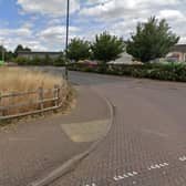 The area to the left of the access road to Cawston's shops has not attracted the hoped-for GP surgery or other community resource so a decision is due on plans to put houses there instead. Photo: Google Street View.