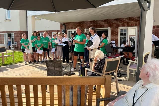 A music charity in Warwick has raised more than £20,000 by cycling 200 miles, enabling it to set up more Memory Singers choirs for people living with dementia.  
Led by TV presenter, wine expert and singer Oz Clarke, the group of cycling musicians from Armonico Consort visited seven care homes, giving mini-concerts, as part of the four-day event. Photo supplied